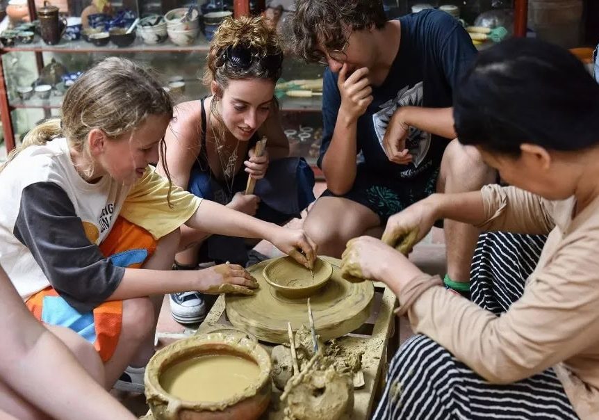 International tourists experience pottery making at Thanh Ha Pottery Village